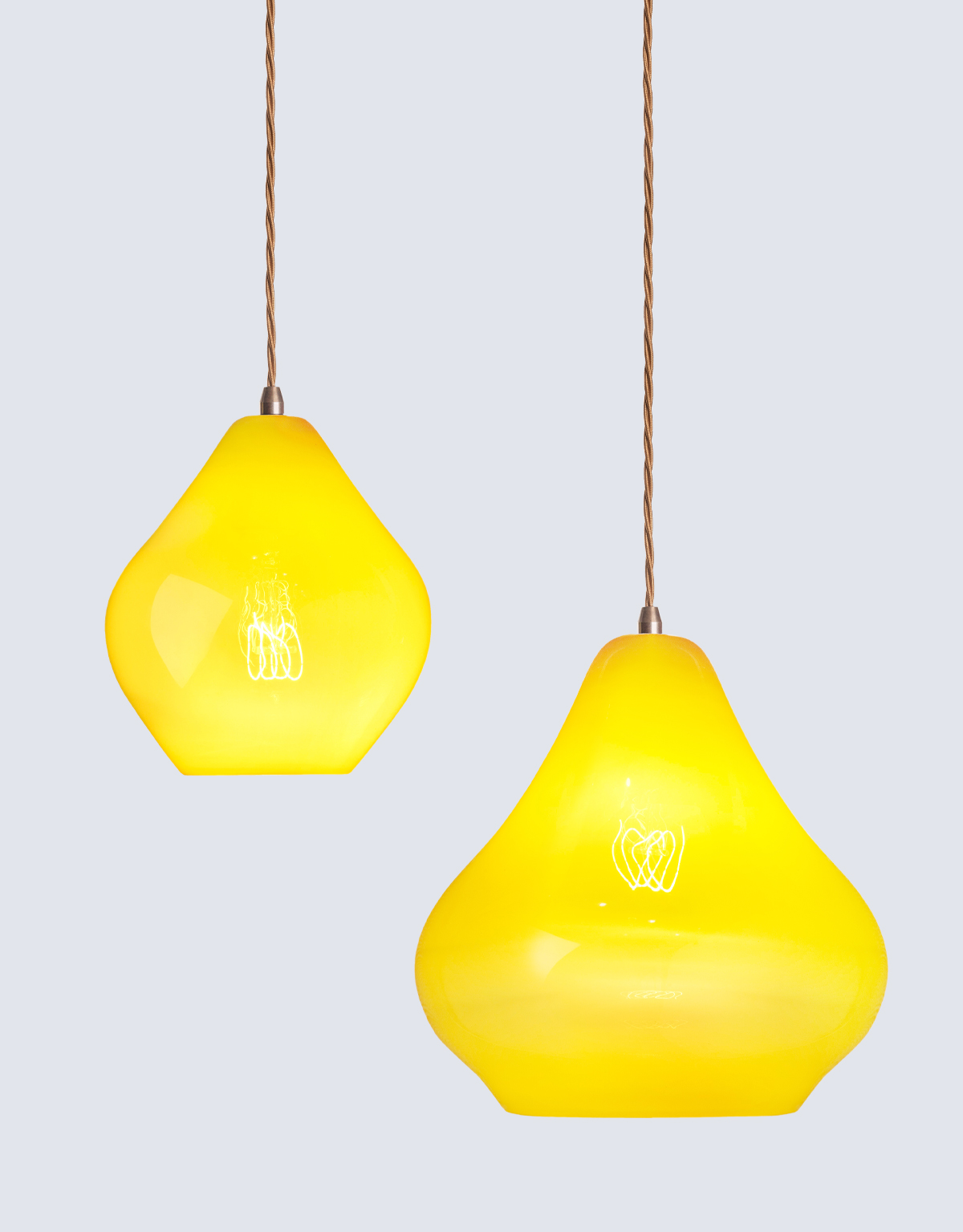 Pair of bright yellow hand-blown glass pendant lights in sizes medium and large.