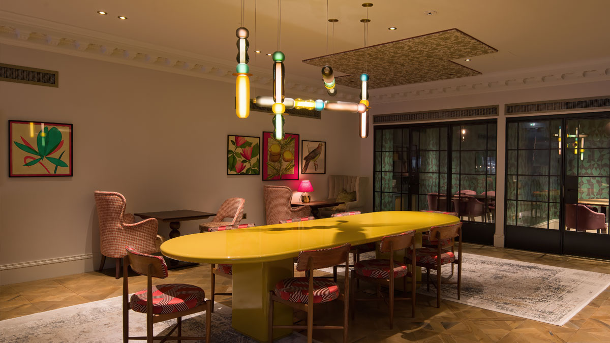 Bespoke modern horizontal chandelier hanging above a large dining table in The Pavilion Club Knightsbridge.