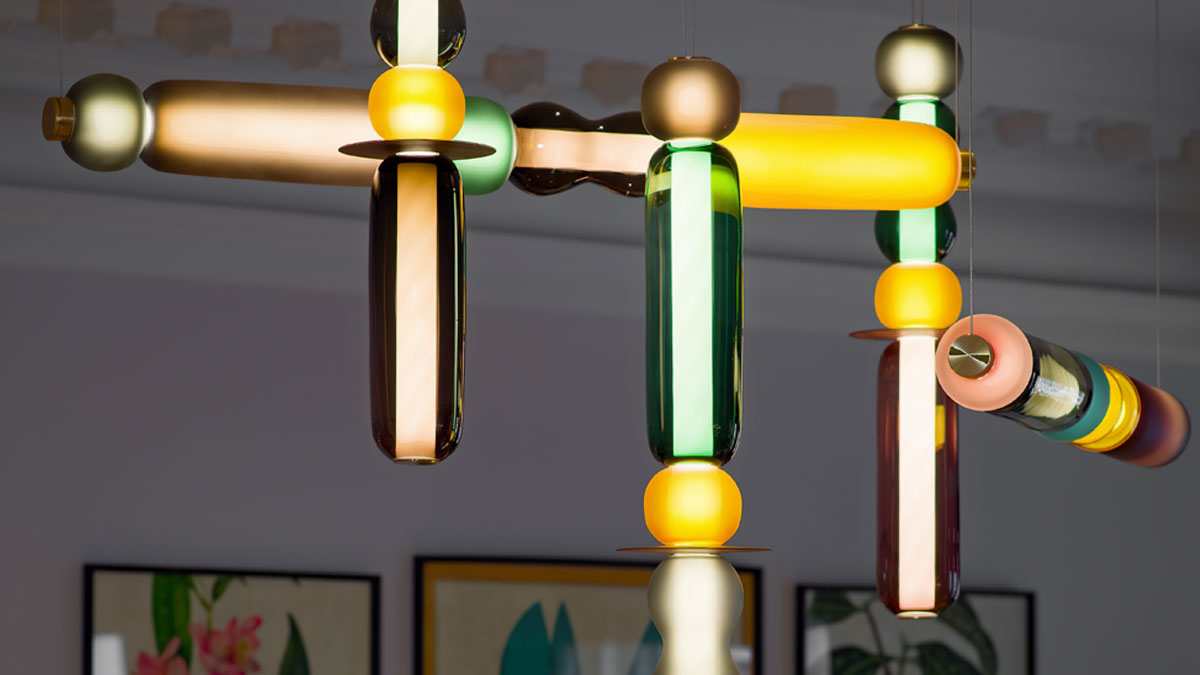 Close up photo of the colourful sculptural glass beam chandelier in the mezzanie lounge at The Pavilion Club in Knightsbridge London