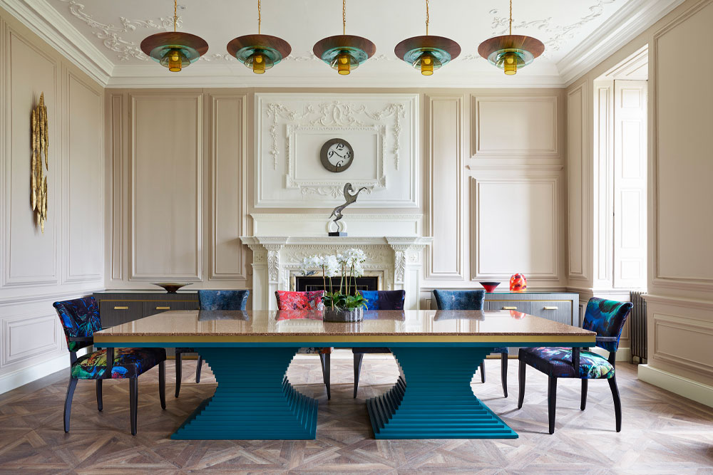 Hand-made statement ceiling lights hanging over large 10 seater dinning table in a luxury period dining room.