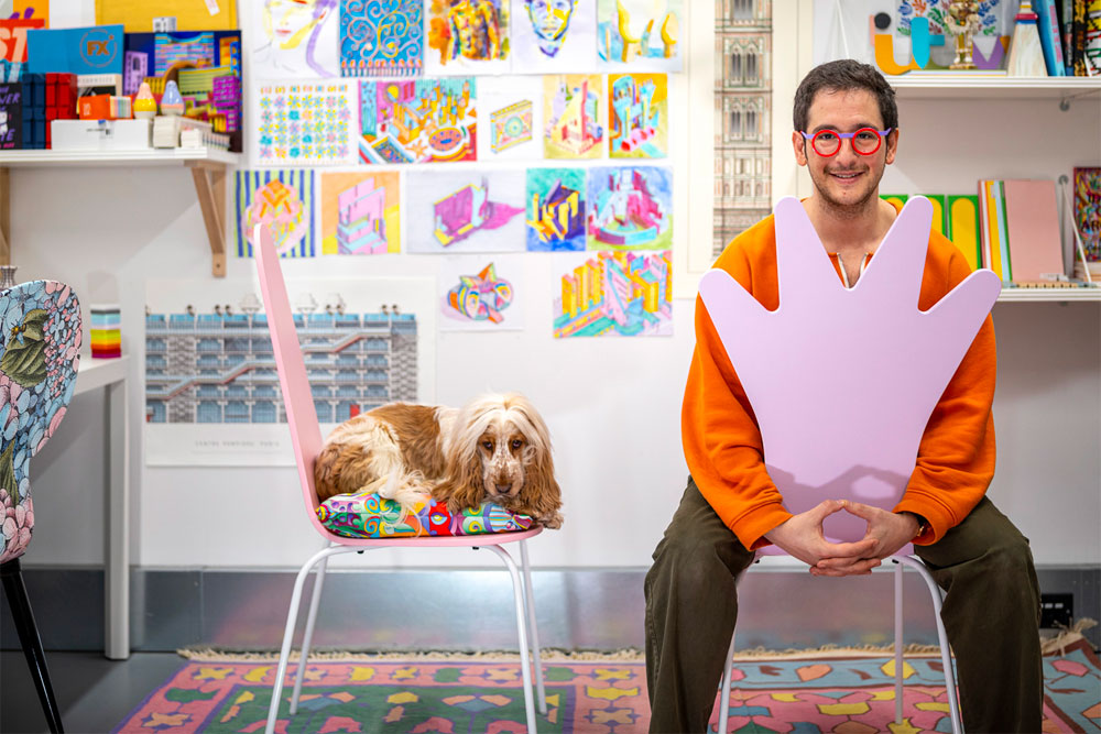 Portrait of Adam Nathaniel Furman in their colourful London Studio. Adam worked in collaboration with Curiousa to design the Glowbule Light Collection which was featured in the 2023 Barbie film.